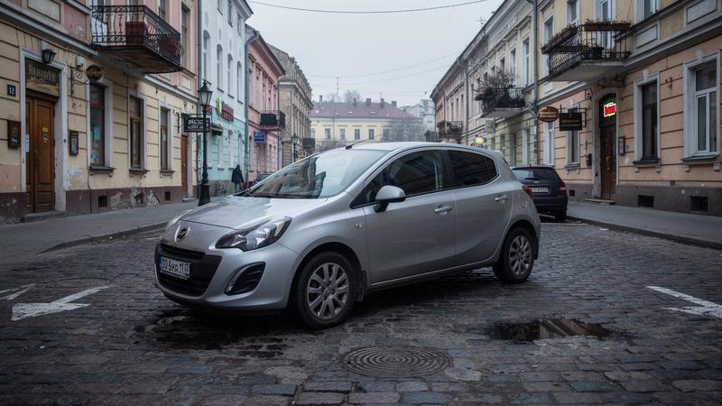 Compact hatchback parked on a cobbled street in Kyiv's old town